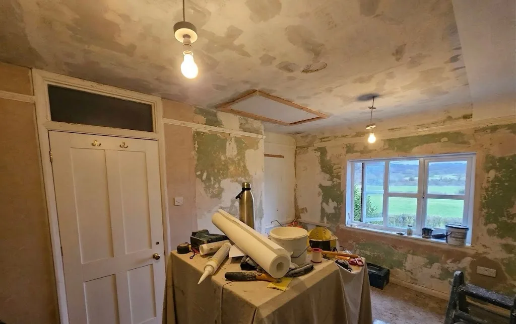 Home study before: stripped walls and a cracked, poorly filled ceiling mid-repair